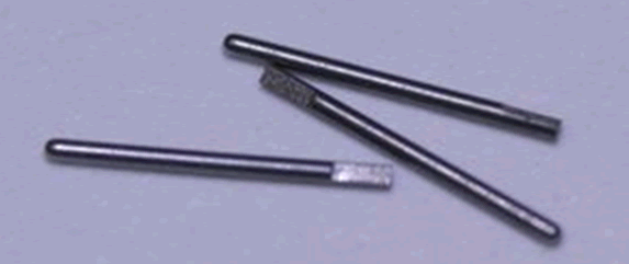 Figure 6: Three 0.015” diameter Kovar (nickel/cobalt alloy) RF pins with notched wire-bond ends