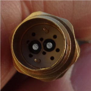 A Reichenbach bulkhead feedthrough receptacle with 2x3A contacts and two fiber optic contacts, about 0.45” diameter and about 0.3 ounces in weight